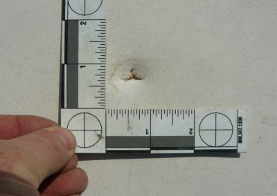 Inspector Measuring Hole In White Roof Material