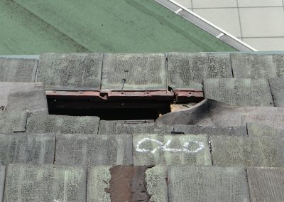 Closeup Of Hole In Tile Roof And White Inspection Marking
